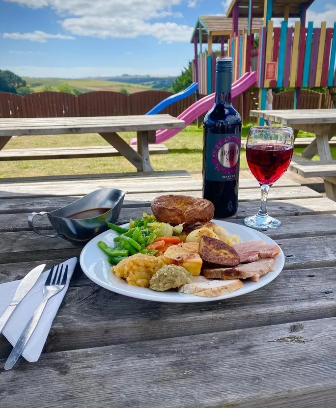 Real carvery plate with roast meats, Yorkshire pudding and trimmings enjoyed outside at The Windy Ridge